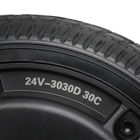 Close-up of a 6.5-inch road tire on a wheel, black rubber with tread and 24V-3030D 30C on the sidewall.