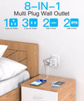 Compact Cube Power Strip With Three USB Ports And USB C Non Surge Protector Outlet Extender plugged into wall near bed