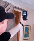 Person using MR160 Imaging Moisture Meter with IGM Tech, Thermal Imaging, Pin And Pinless Detection, 80x60 Resolution indoors.