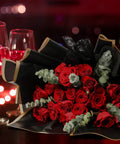 Waterproof Flower Wrapping Paper Set 20 Sheets Black Floral Bouquet Paper For Gift Wrapping Florist Supplies For Weddings And DIY Gift Packaging 22.8 By 22.8 Inches used to wrap red roses with wine glasses in background.