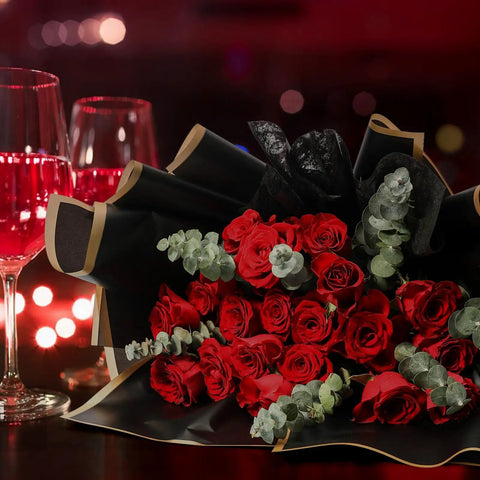 Waterproof Flower Wrapping Paper Set 20 Sheets Black Floral Bouquet Paper For Gift Wrapping Florist Supplies For Weddings And DIY Gift Packaging 22.8 By 22.8 Inches used to wrap red roses with wine glasses in background.