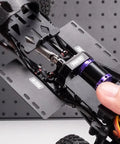 Beefed Up Aluminum Side Plates For 1/24 Axial SCX24 RC Crawler ESC Receiver Tray showcasing black metal upgrade.