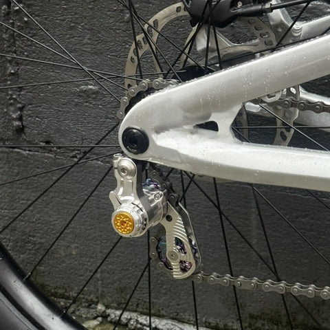 Close-up of Single Speed Chain Tensioner Kit For Hardtail MTB BMX DJ And Folding Bikes, CNC 6061 Aluminum, mounted on bike frame.