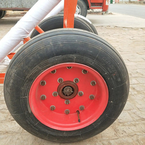 Beefed Up Heavy Duty Double Utility Pole Dolly With Two Wheel Concrete Pole Transport Cart For Electrical Crews Built Tough With Solid Steel Frame Easy Maneuver On Rough Job Sites And Heavy Poles, dual pneumatic wheels close-up