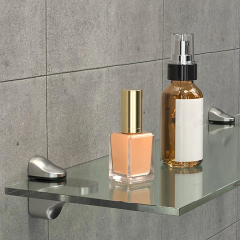 Bathroom scene with items on a glass shelf supported by adjustable glass shelf bracket wall mount made from zinc alloy gold finish shelf supports that grips tight for 3mm to 22mm glass panels ideal for home decor display shelves and storage
