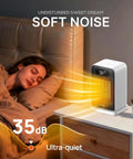 Cozy Up Quick Heat Space Heater With Dual 1500 And 900W Power illuminating next to a sleeping person on a nightstand.