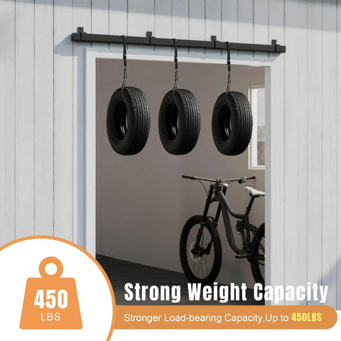 10 Foot Exterior Sliding Barn Door Hardware Kit Box Rail Track 450 Pound Capacity Black Weather Resistant Steel Wall Mount System For Outdoor Use Fits Double 30 Inch Doors installed on white wall with tires hanging.