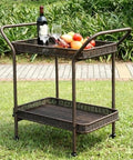 Wicker Patio Serving Cart With All Weather Resin Wicker And Durable Steel Frame Espresso Finish The Go To Outdoor Entertaining Cart With Two Storage Shelves For Deck Or Backyard Parties on grass.