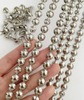 Five Meter Upholstery Tack Strips Featuring Nine Point Five Millimeter Nickel Finished Heads And Included Single Nails For Slick Furniture Makeovers And Dope DIY Home Upgrades displayed in hand with nails.