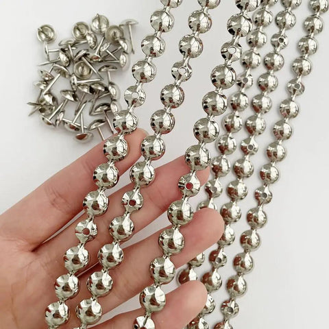 Five Meter Upholstery Tack Strips Featuring Nine Point Five Millimeter Nickel Finished Heads And Included Single Nails For Slick Furniture Makeovers And Dope DIY Home Upgrades displayed in hand with nails.