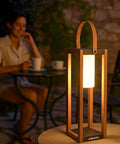 Rustic Solar Lantern For Outdoor Use With Portable Handle, illuminating a patio table with warm light, 22 Inch Tall