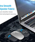 World Map XXL Mouse Pad 35.4 By 15.7 Inch With Non Slip Rubber Base And Stitched Edges Beast Desk Mat next to laptop