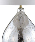 Close-up of Mercury Silver Glass Teardrop Table Lamp With White Linen Drum Shade for Living Room or Bedroom with brass accents.