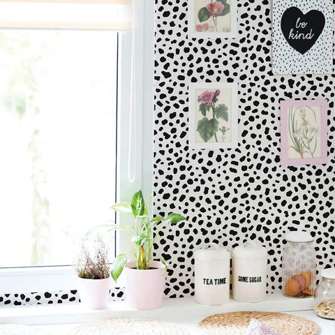 Room with Removable Peel And Stick Wallpaper With Modern Hand Drawn Spot Pattern Easy Grab And Go DIY Accent, framed art, and plants.