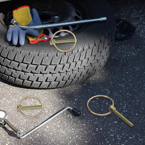 Beefy Heavy Duty Lynch Pin Assortment Kit 12 Piece 3/16 Inch Hitch Pins With Locking Clips shown near tire and tools