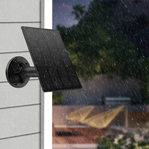 Two Pack Solar Panel Kit For Wireless Outdoor Security Cameras mounted on wall in rain