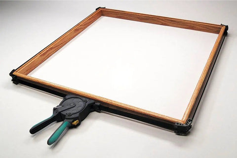 One-Hand Ratcheting Band Clamp For Quick Glue-Ups And Framing, 16-Inch Clamp With Self-Adjusting Corners in use on a wooden frame