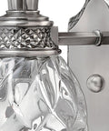Close-up of Plantation Style One Light Bathroom Vanity Fixture in Polished Antique Nickel with Silver Patina Finish, showing glass detail.