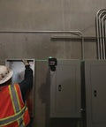 Boss Class 12V Max Three Plane Green Beam Laser Level in use on a construction site for precise alignment of electrical boxes.