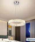Modern bedroom with crystal chandelier, circular flush mount design, farmhouse style black globe pendant light with adjustable chain.