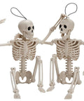 Two Pack 16 Inch Poseable Hanging Skeletons With Movable Joints For Halloween Decor, sitting with playful poses