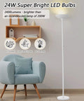 Antique Silver Torchiere Floor Lamp With 24W LED, 3000K Dimmable Brightness, Rotary Switch, 70 Inch Tall Metal Standing Lamp, 2400 Lumens, Home Upgrade For Living Room Bedroom Office Den next to a modern chair in a cozy living room setting.