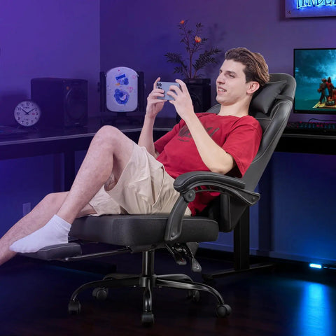 All Day Comfy Ergonomic Gaming Chair With Footrest And Recline Headrest And Lumbar Support Linkage Armrests Heavy Duty 350 Lbs Capacity High Back Office Chair For Home Use Black in a gaming setup.