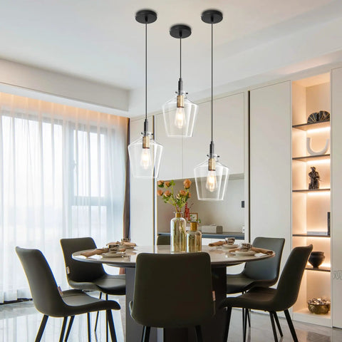 Modern Black And Gold Glass Pendant Light 2 Pack With Adjustable Height Cord For Kitchen Island Clear Round Shade E26 Socket overhead in dining area.