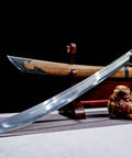 Xiuchun Dao Chinese Sabre Hand Forged Manganese Steel With Teak Wood Scabbard And Textured Alloy Fittings displayed on stand