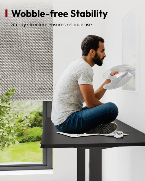 Heavy Duty Dual Motor Electric Standing Desk 71 By 32 Large height adjustable workstation, sturdy structure supporting user painting.