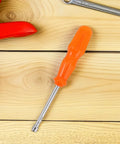 Heavy Duty Hex Socket Screwdriver Wrench With Swappable Bits For Nuts And Bolts on wooden surface, matte orange handle.
