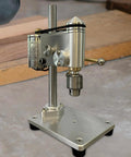 Mini Bench Drill Press With Vibration Free Station And Metal Construction on a flat surface, showcasing its sturdy design and precise chuck mechanism.