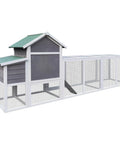 Spacious Wooden Chicken Coop And Rabbit Hutch For Outdoors With Nesting Box, waterproof roof, and sliding door in backyard setting.