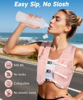 Reflective Hydration Vest With 500ml Soft Flask And Phone Holder Go To Lightweight Running Pack For Men And Women Adjustable Water Bottle Vest No Bounce Stability Ideal For Training And Hiking Pink worn by runner drinking from soft flask