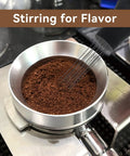 Espresso Distribution Tool With 0.4mm 10 Needle Stirrer Break Up Grounds Reduce Channeling Achieve Even Extraction For Home And Commercial Espresso Machines Black in use, stirring coffee grounds in portafilter.