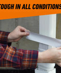 Applying Heavy Duty White Duct Tape 1.88 Inch Wide, 30 Yard Roll Pack Of 2 to outdoor pipe, showing its UV resistant feature.