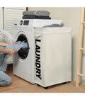 Big Ol Extra Large 27 Inch Slim Rolling Laundry Basket On Wheels With Removable Bag next to washing machine in laundry room