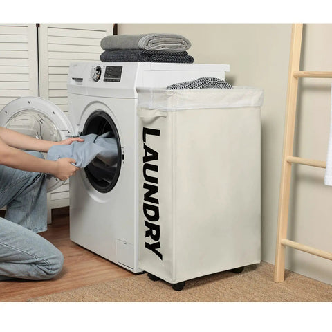 Big Ol Extra Large 27 Inch Slim Rolling Laundry Basket On Wheels With Removable Bag next to washing machine in laundry room