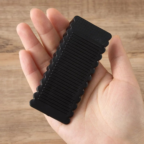 Rock Solid Black Rubber Wedge Shims For Furniture Leveling Hella Sturdy Anti Slip Wobble Pads To Smooth Uneven Floors And Zero Shake Universal Cabinet Stabilizers held in hand.