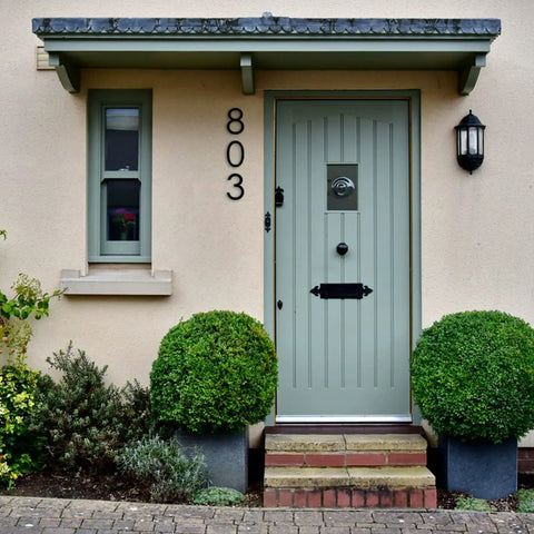 Front door with 8 Inch Floating House Number 1 Easy To Read From Street Modern Metal Mount, placed on a cream wall.