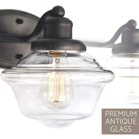 Close-up of 26 Inch 3 Light Traditional Schoolhouse Vanity Light with clear glass shade and gray finish for classic bath style.