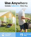 Beat The Heat Anywhere Portable Misting System with 20L water bag shown under canopy and carried by man outdoors