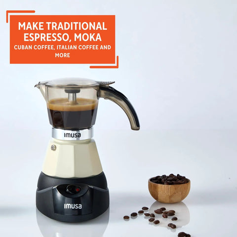 Dang Compact Two Cup Electric Espresso Maker With Cool Touch Handle brews coffee on a sleek countertop with coffee beans nearby.