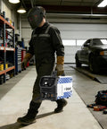 Person holding Garage Ready 210A 4 In 1 Mig Tig Stick Welder 120V Gas Or Gasless Flux Core Mig Lift Tig IGBT Inverter in garage