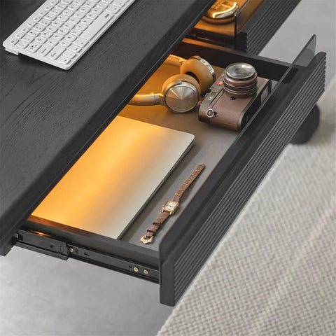 Super Sturdy Electric Standing Desk With Dual Storage Drawers And Whisper Quiet Lift Features A Heavy Duty Ash Wood Desktop In Crisp Matte Black showing open drawer with laptop, headphones, camera, and accessories.