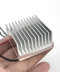 4 Pack Anodized Aluminum Heat Sinks 40 By 40 By 20mm Kit held in hand, showing aluminum fins for passive cooling of electronics.