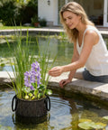 Woman placing plant in water with 4 Pack Aquarium Plant Baskets Mesh Water Planting Bags Foldable For Hydroponics And Pond Use
