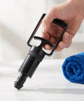 Hand holding Universal Replacement Manual Cupping Pump With Ergonomic Grip For Vacuum Cups beside a rolled blue towel.