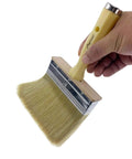 Heavy Duty 5 Inch Paint Brush With Screwed Extended Handle For Decks And Fences Stain Block Poly Bristle Blend Ideal For Walls Masonry And Large Painting Projects Pack Of 6 pictured being held by a hand.