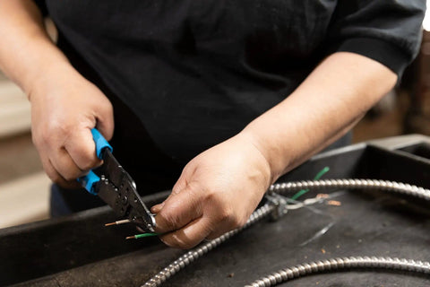 Person using 6-1/4 Inch Wire Stripper And Cutter With No-Fuss Durable Blue Handles For Electrical Wiring, precise cutting action